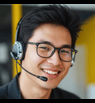 A smiling customer support representative wearing a headset, conveying approachability, professionalism, and responsive assistance.